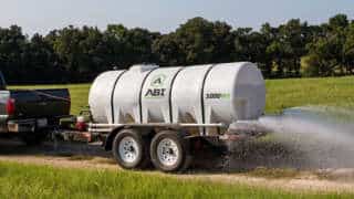 Truck Hauling 1000 Gallon Water Trailer Dust Abatement