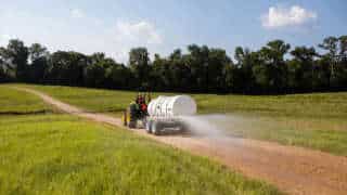 Tractor 1000 Gallon Water Trailer Long Dirt Road